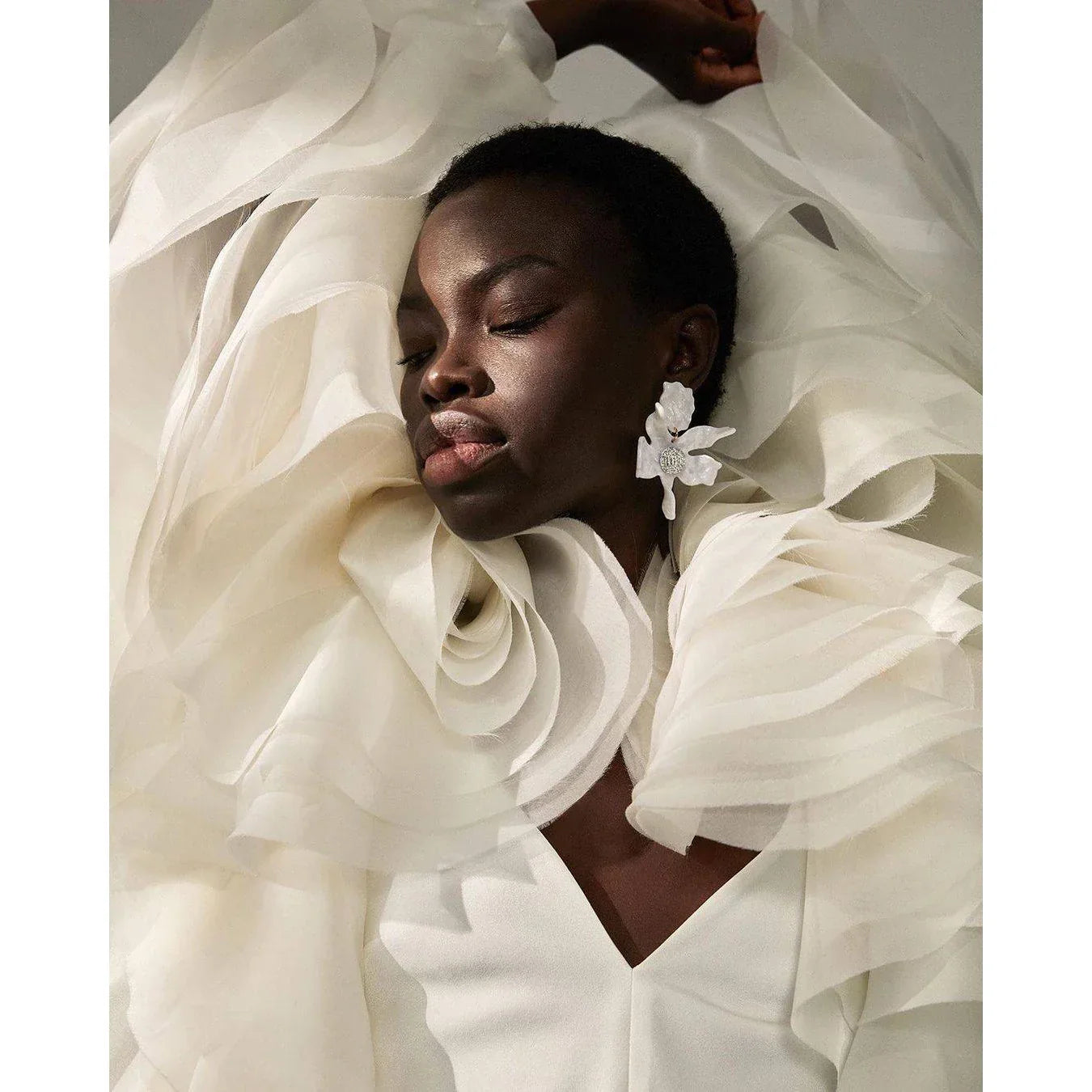 Unique white ruffled suit with dramatic layered sleeves and tailored fit